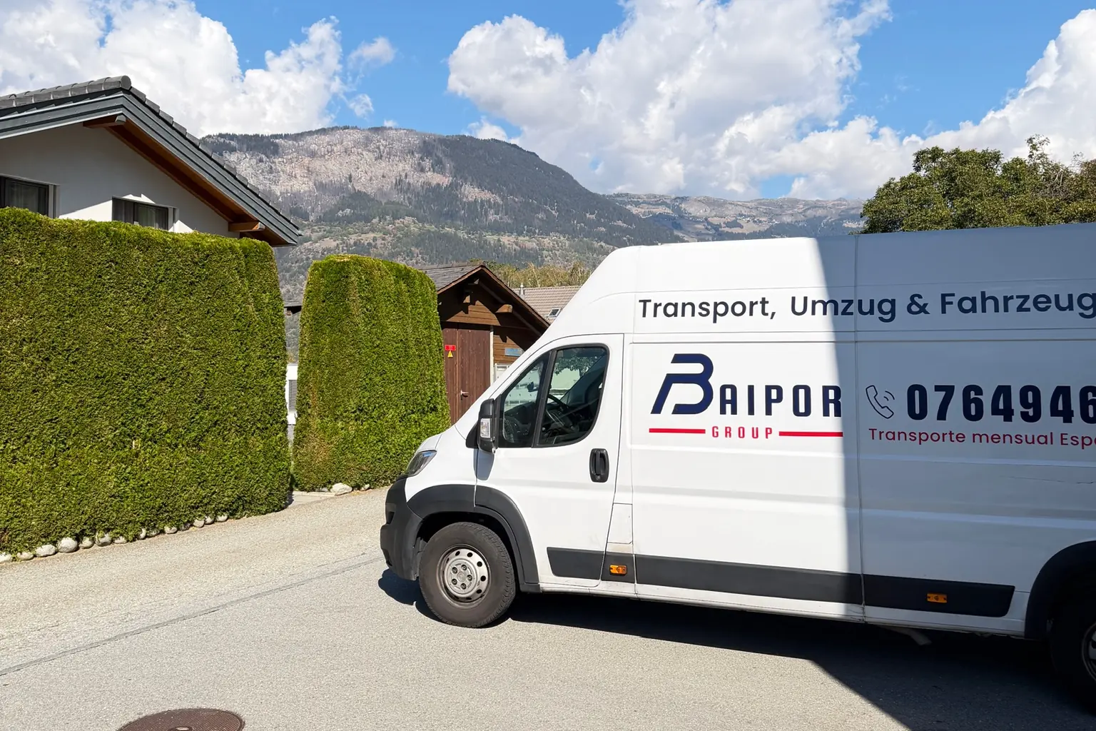 Baipor Group branded van parked in Switzerland, with mountains and blue sky behind